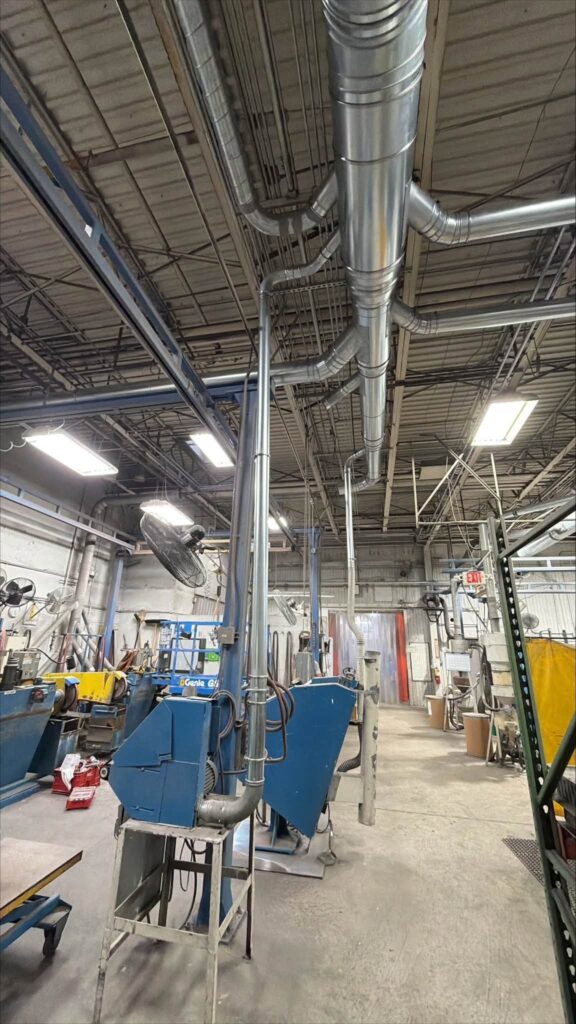 Branch ductwork and flexible hose connections at the equipment.
